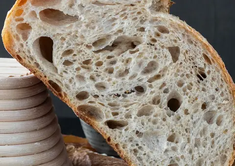 A sliced sourdough loaf with an open crumb