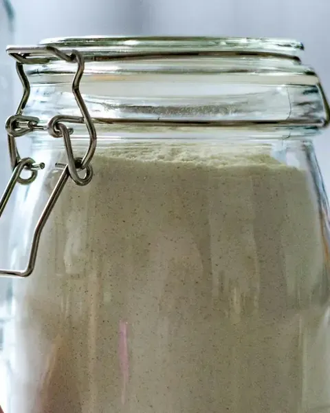 Flour stored in a glass jar with a clip lid